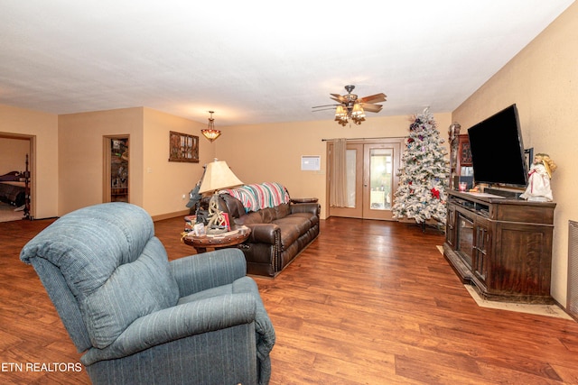 living room featuring wood-type flooring, french doors, and ceiling fan