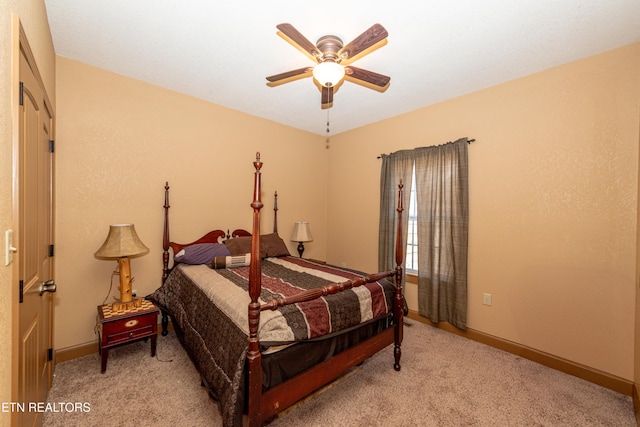 bedroom featuring ceiling fan and light carpet