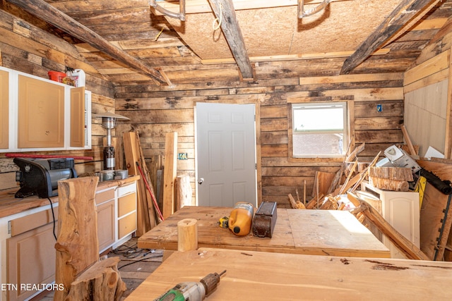 interior space with vaulted ceiling with beams, wood walls, and wood ceiling