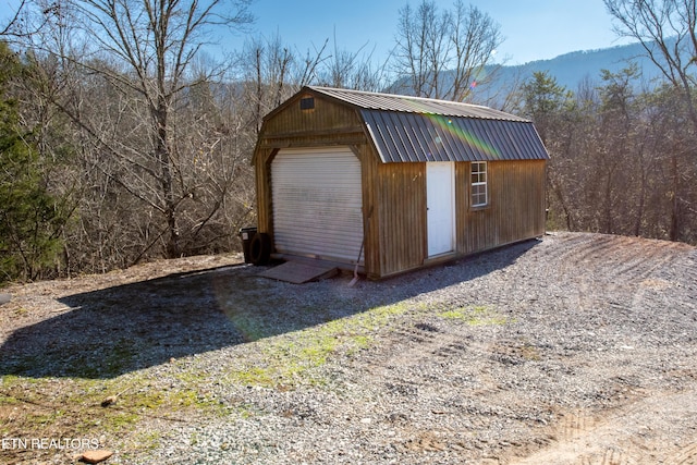 view of outbuilding with a mountain view and a garage