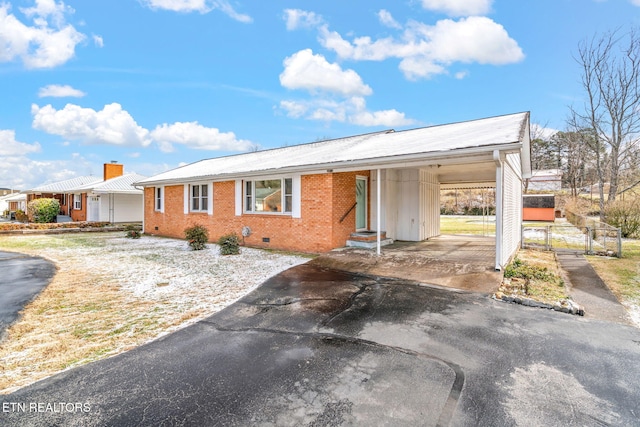 ranch-style home featuring a carport