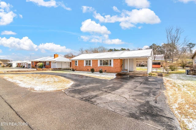 single story home featuring a carport