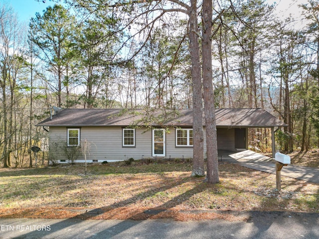 ranch-style home with a carport and a front lawn