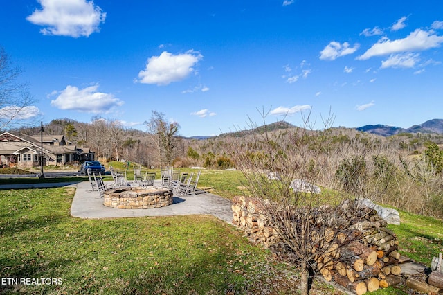 view of yard featuring a fire pit and a mountain view