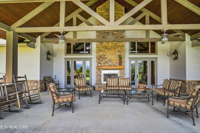 view of patio / terrace featuring an outdoor living space with a fireplace and ceiling fan