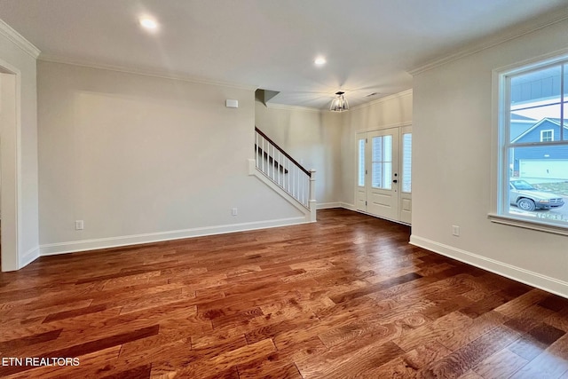 unfurnished living room featuring crown molding and dark hardwood / wood-style floors