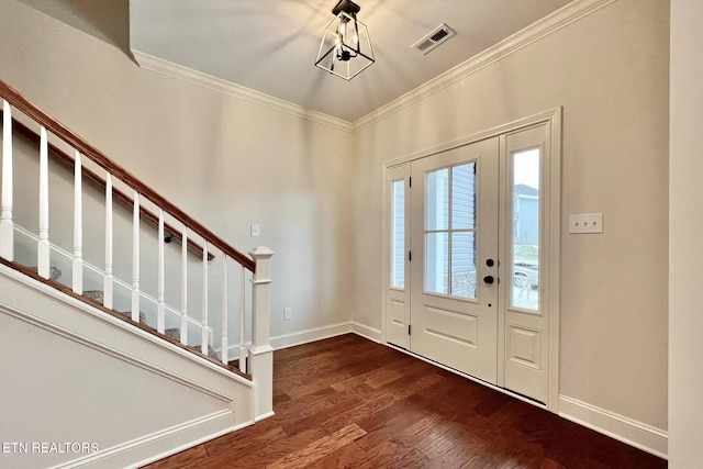 foyer featuring dark hardwood / wood-style flooring and crown molding