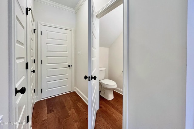 bathroom with toilet, hardwood / wood-style flooring, and ornamental molding