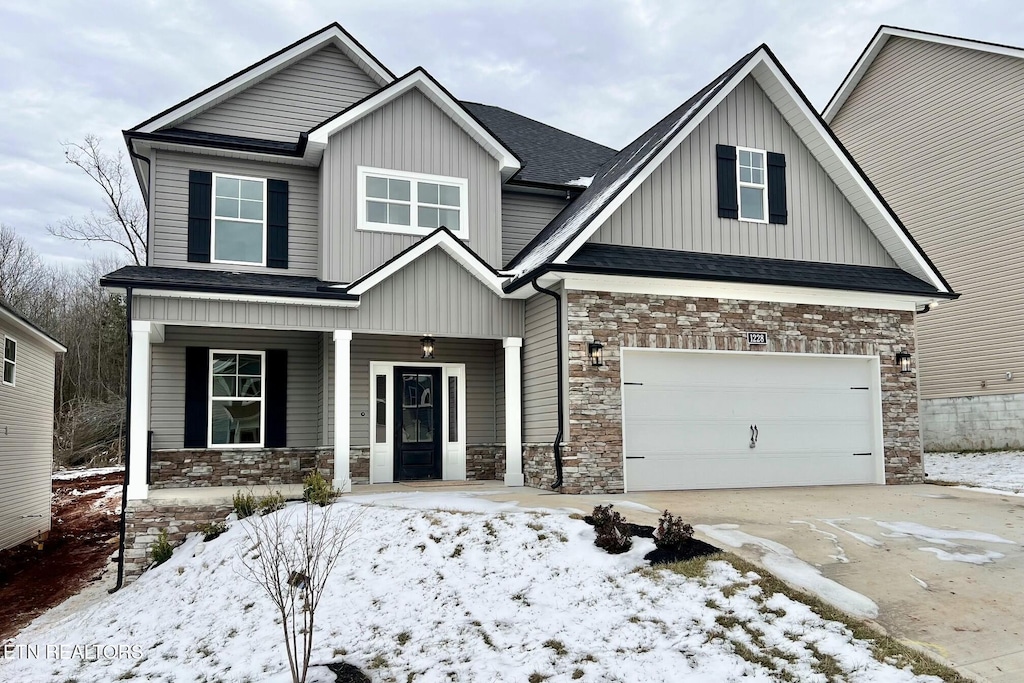 craftsman-style house featuring covered porch and a garage