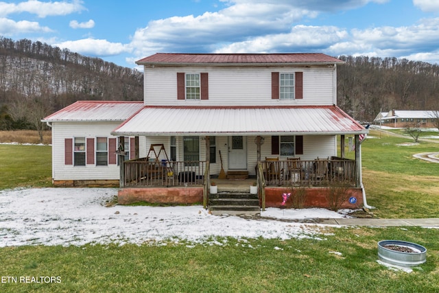 farmhouse inspired home with a front lawn and a porch