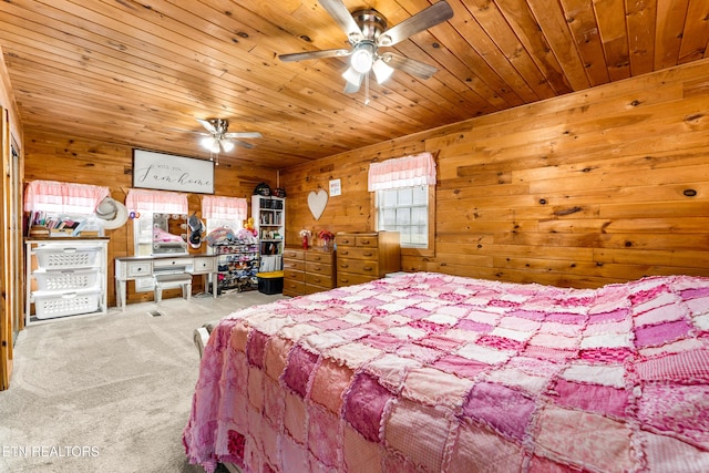 bedroom featuring ceiling fan, carpet, wood ceiling, and wooden walls