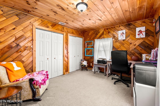 office space with carpet flooring, wood ceiling, and wooden walls