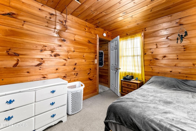 carpeted bedroom with wood ceiling