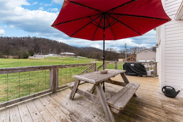 deck with grilling area and a yard