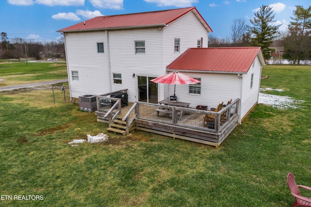 back of house featuring cooling unit, a deck, and a yard