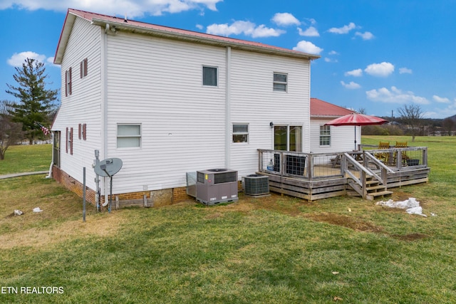 back of house featuring a wooden deck, cooling unit, and a yard