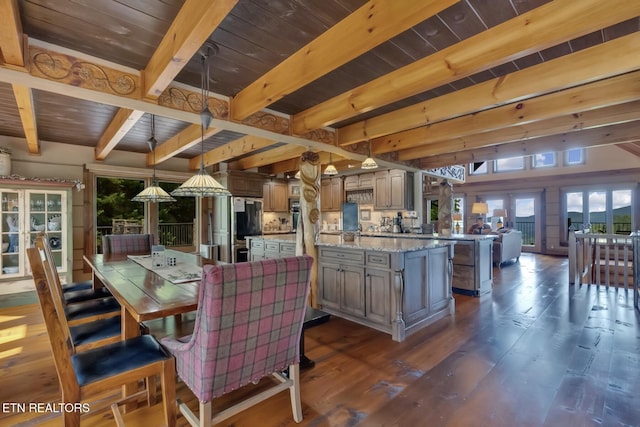 dining room featuring beam ceiling, dark hardwood / wood-style flooring, and wood ceiling