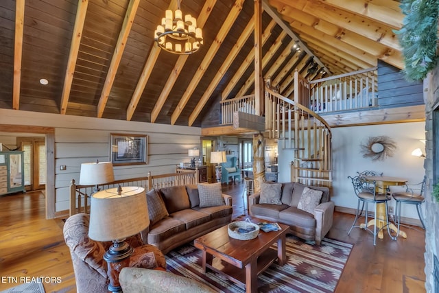 living room with hardwood / wood-style floors, wood walls, wooden ceiling, high vaulted ceiling, and a notable chandelier