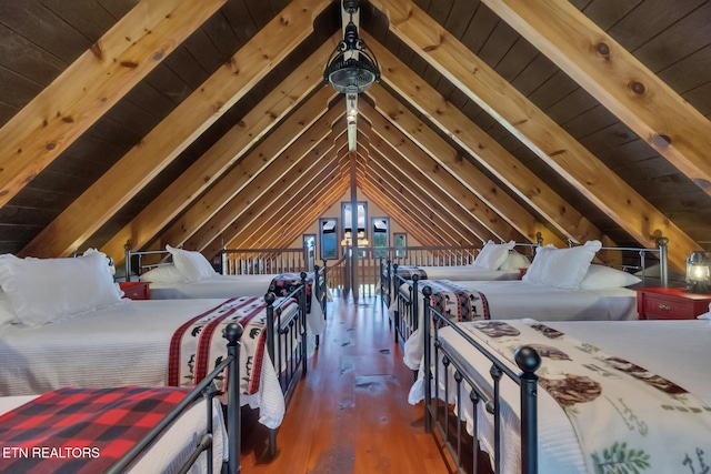 bedroom featuring lofted ceiling with beams, dark hardwood / wood-style floors, and wooden ceiling