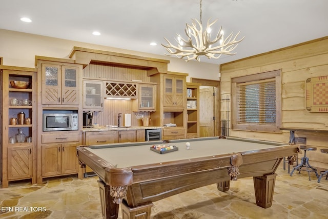 game room with indoor wet bar, wooden walls, a notable chandelier, billiards, and wine cooler