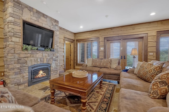 living room with wood walls and a fireplace