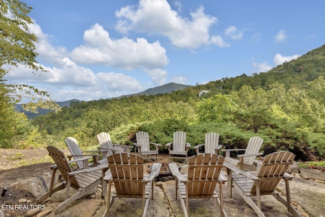 view of patio / terrace featuring a mountain view and an outdoor fire pit