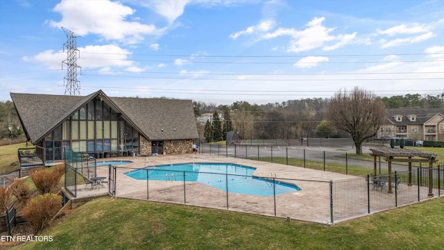 view of swimming pool featuring a patio area, a yard, and an in ground hot tub