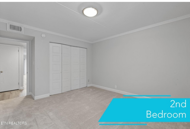 unfurnished bedroom featuring a closet, ornamental molding, and light colored carpet