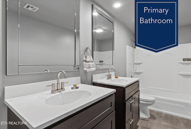 full bathroom featuring toilet, vanity, tile patterned flooring, and shower / bathtub combination