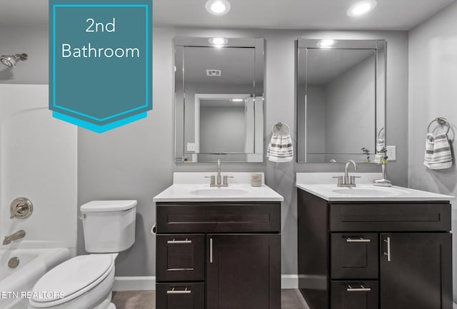 full bathroom with toilet, vanity, and shower / bathtub combination