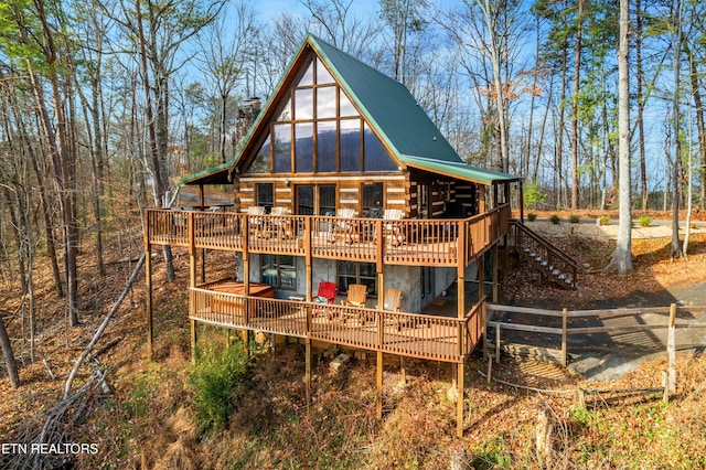 back of house with a wooden deck