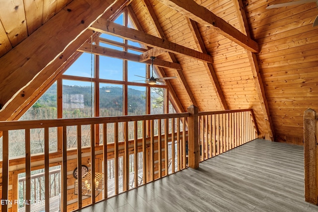 additional living space featuring vaulted ceiling with beams, ceiling fan, a mountain view, and wooden ceiling