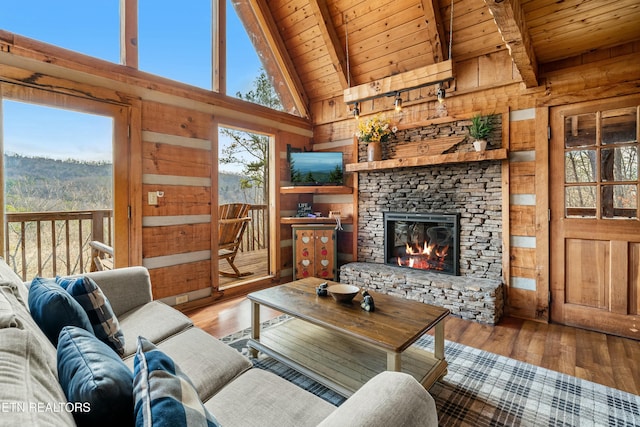 living room with beam ceiling, wood walls, hardwood / wood-style floors, and wood ceiling