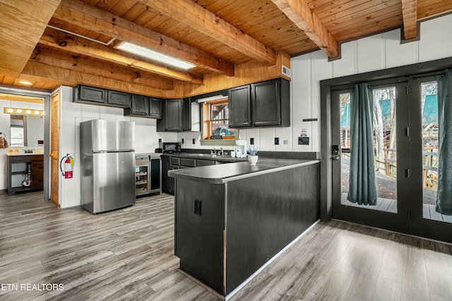 kitchen featuring wood ceiling, stainless steel refrigerator, light hardwood / wood-style floors, kitchen peninsula, and beverage cooler