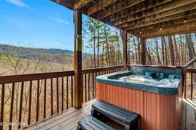 wooden terrace featuring a hot tub