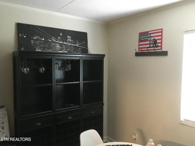 bedroom with crown molding and a textured ceiling