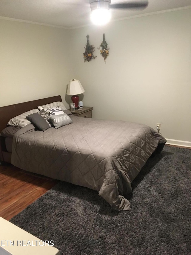 bedroom featuring crown molding, ceiling fan, and hardwood / wood-style flooring