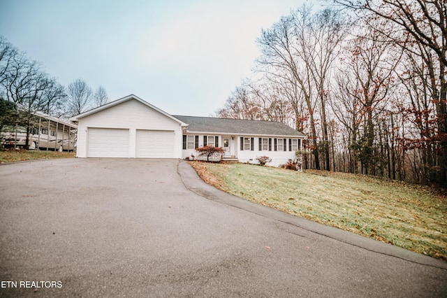 ranch-style home with a front lawn and a garage