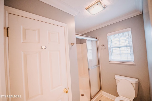 bathroom featuring toilet, crown molding, and walk in shower