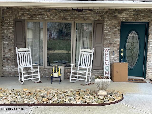 view of exterior entry with covered porch