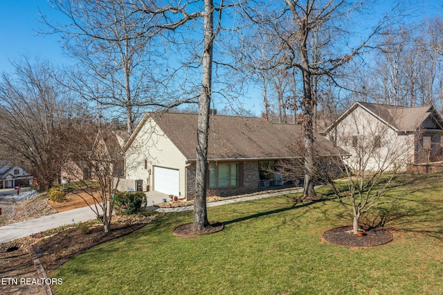 view of front facade featuring a front yard, brick siding, driveway, and an attached garage