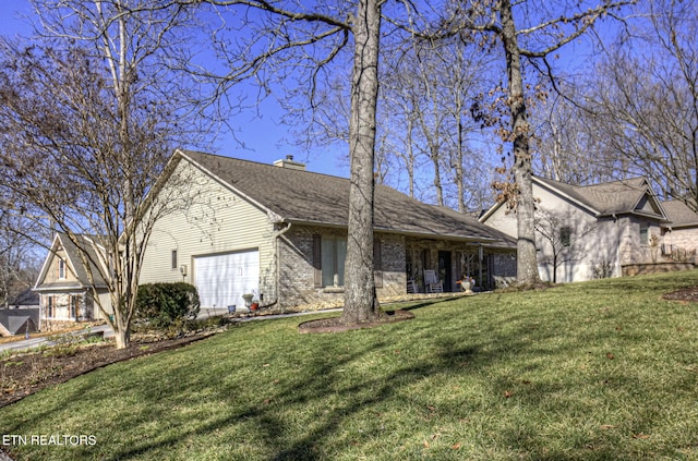 view of front of home featuring brick siding, roof with shingles, a chimney, a front yard, and a garage