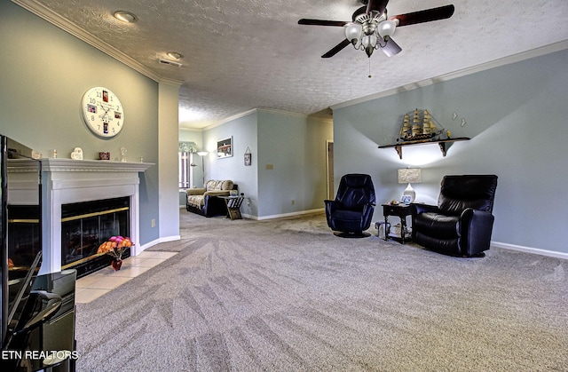 sitting room with a textured ceiling, light colored carpet, a fireplace with flush hearth, baseboards, and ornamental molding