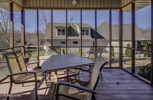 sunroom / solarium featuring a residential view