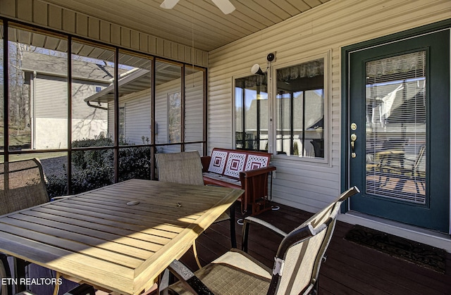 sunroom with a healthy amount of sunlight, ceiling fan, and wood ceiling