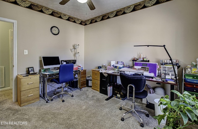 carpeted home office with a ceiling fan and visible vents