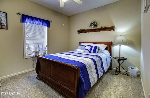 carpeted bedroom with a ceiling fan and baseboards