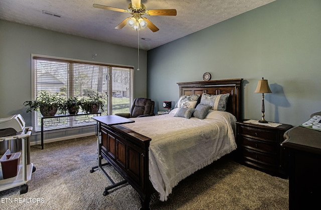 bedroom with baseboards, visible vents, a ceiling fan, carpet, and a textured ceiling