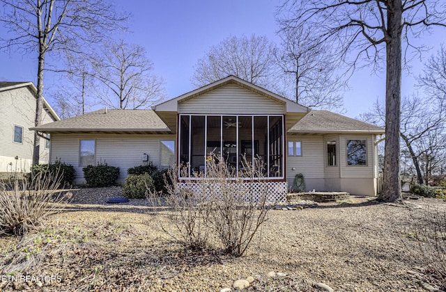 view of front of property with a sunroom and roof with shingles