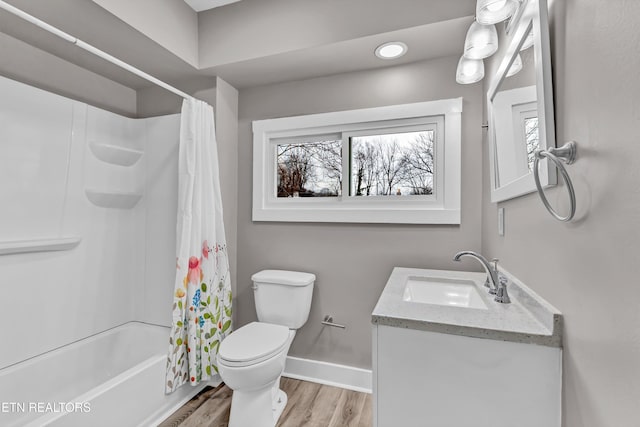 full bathroom featuring hardwood / wood-style floors, vanity, toilet, and shower / bath combo with shower curtain